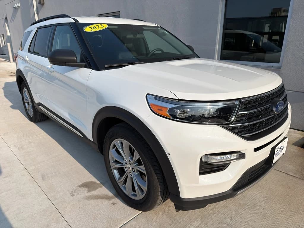 Sugar Loaf CDJR source photo of a white Ford Explorer XLT at the dealership with a dealer plate and yellow 2023 windshield sticker