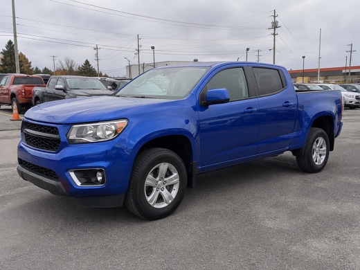 generic blue pickup in a cluttered dealership lot